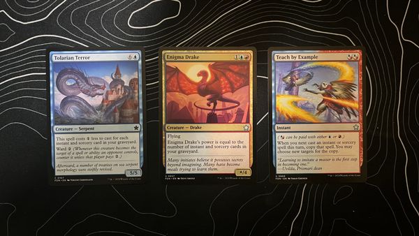 A Tolarian Terror, Enigma Drake, and Teach by Example from the Magic: The Gathering Foundations set.