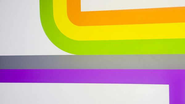 A photo I took from my phone of my computer screen. There's lines of orange, yellow, and green coming from above that meet up with lines of grey and purple that are coming from the left.