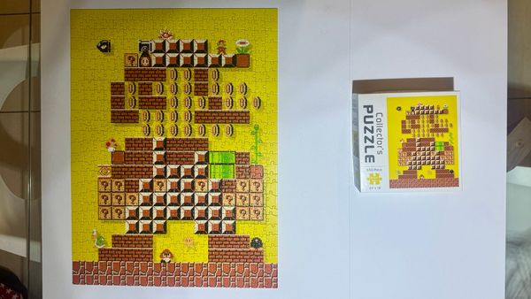 My completed Mario Maker Collector's Puzzle next to its box.