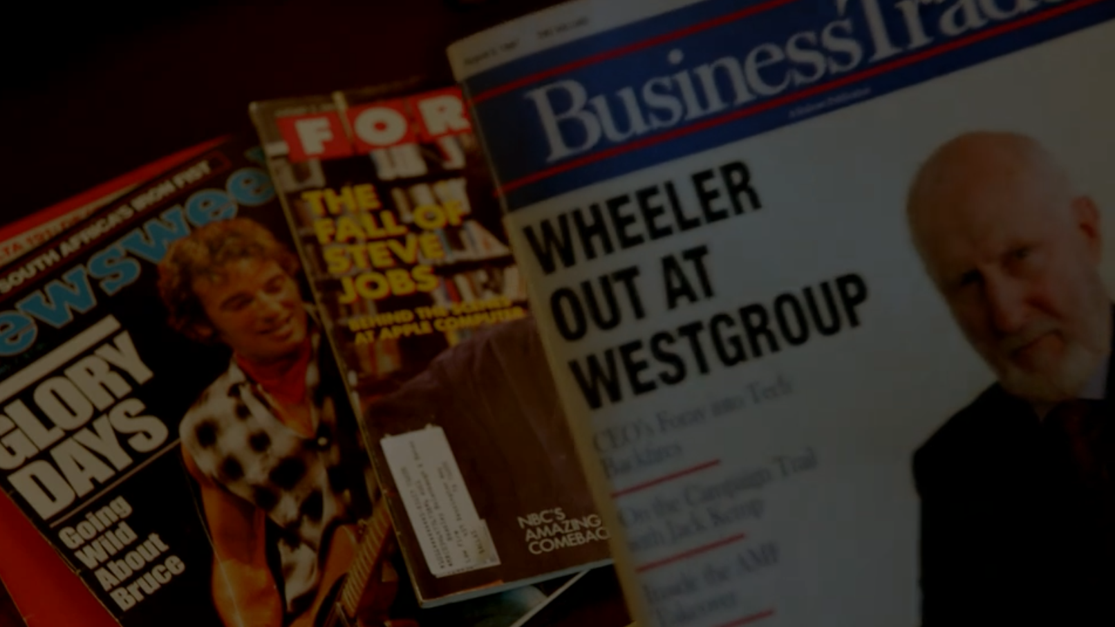 A fake magazine cover with a headline saying "Wheeler out at Westgroup" over real covers of Fortune (discussing Steve Jobs' ouster at Apple) and Newsweek (Bruce Springsteen) from 1985.