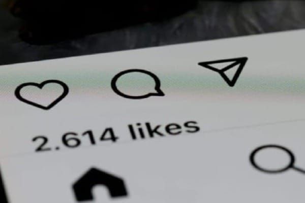 Close-up of Instagram interface showing 2,614 likes and engagement icons: heart, comment, message, and search symbols