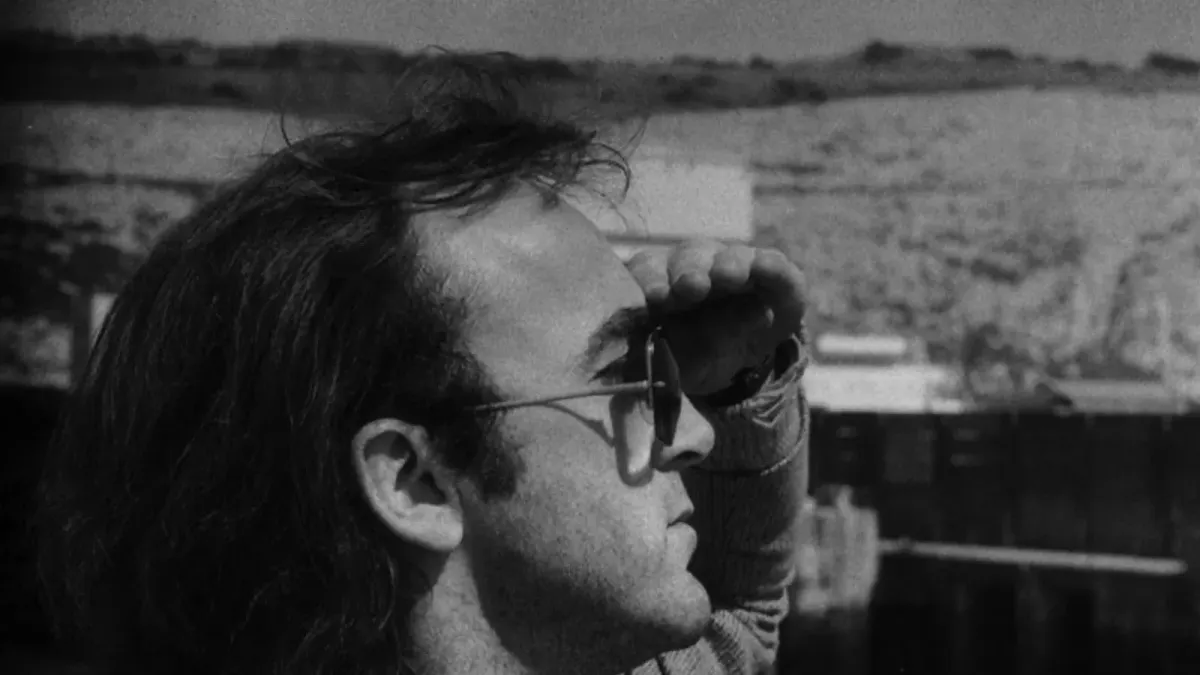 Ollie Halsall wearing sunglasses outdoors, photographed in profile.