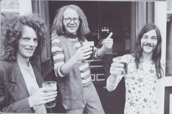 Dr. Strangely Strange raising glasses outside a pub.