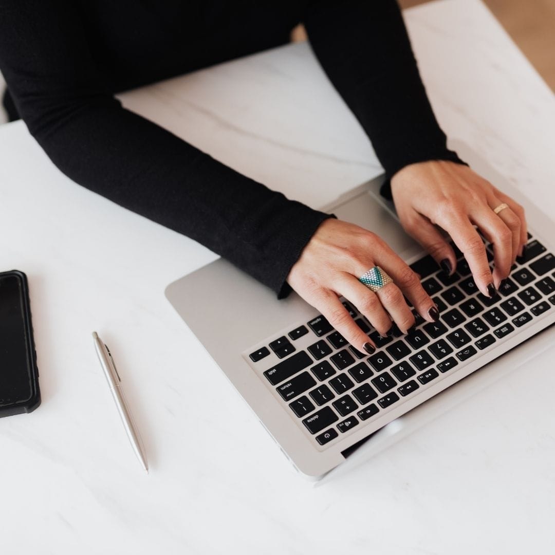 A woman typing on a computer.