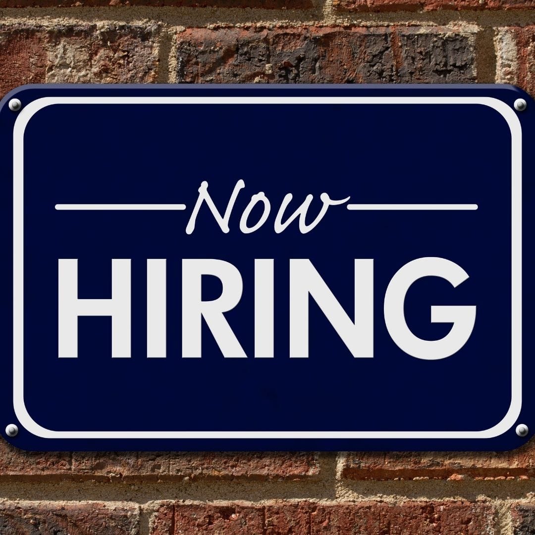 A Now Hiring sign.