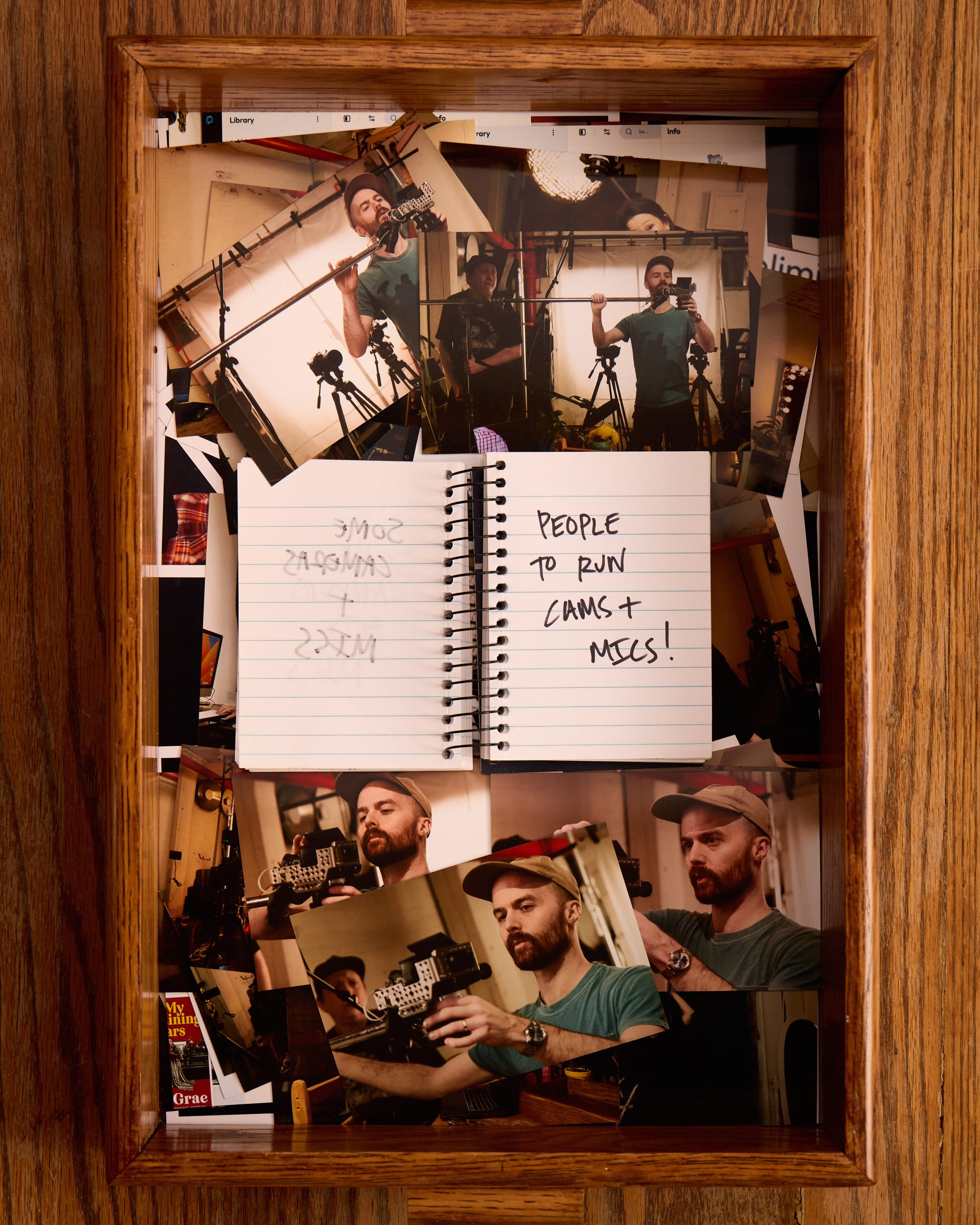 The notebook now says “People to run cams + mics (Jeremy Balon and Eric Durkin)” In the tray of 4x6 photos, Eric Durkin and Jeremy Balon are pictured working on the podcast set. 