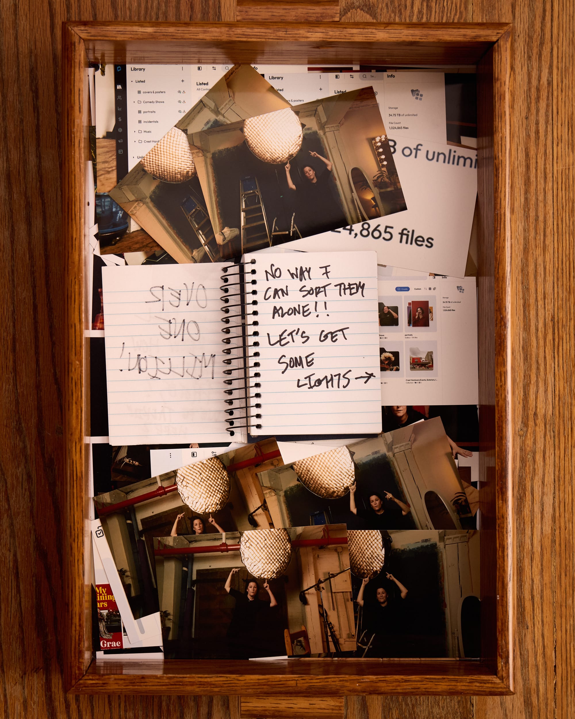  The notebook now says “No way I can sort them alone!! Let's get some lights...” In the tray of 4x6 photos, Mindy points to several different video lights on the podcast set. 
