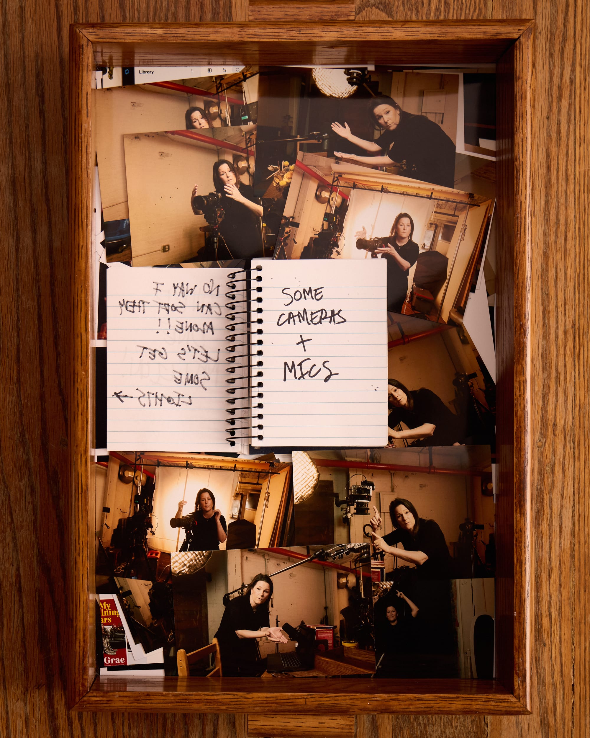  The notebook now says “Some cameras + mics” In the tray of 4x6 photos, Mindy points to several different cameras on the podcast set. 