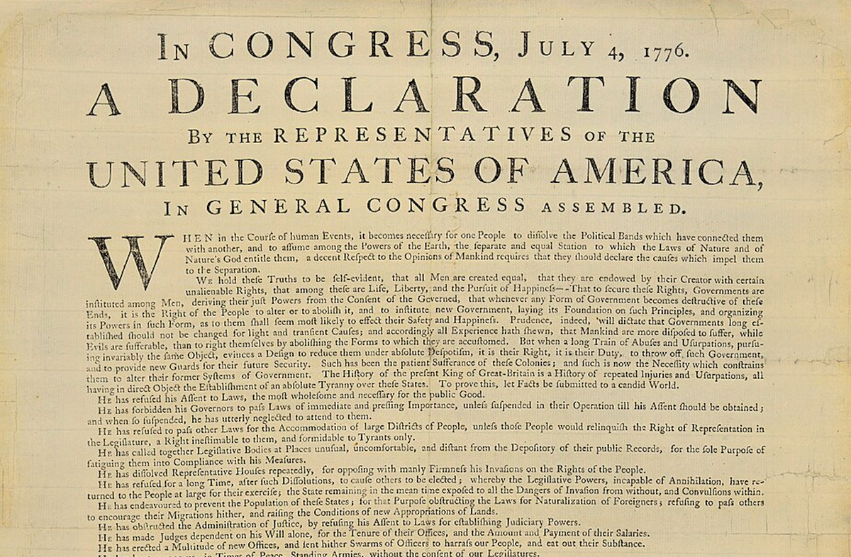 A yellowing page with fading black print - the top third of the Declaration of Independence