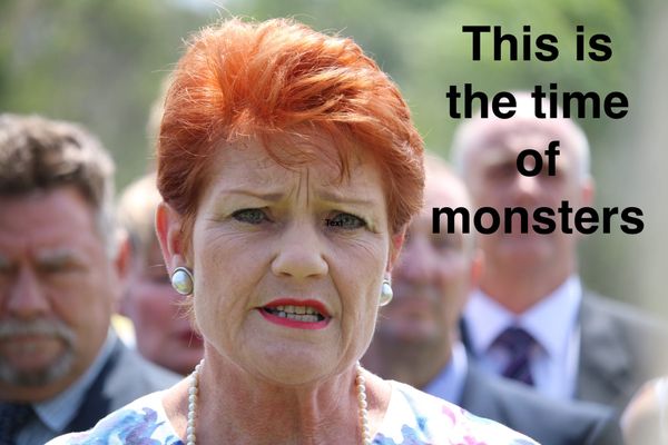 A white woman with dyed red hair, pink lipstick, large earrings & pearls grimaces at the camera. She's in front of a bunch of white men. I added text reading "This is the time of monsters"