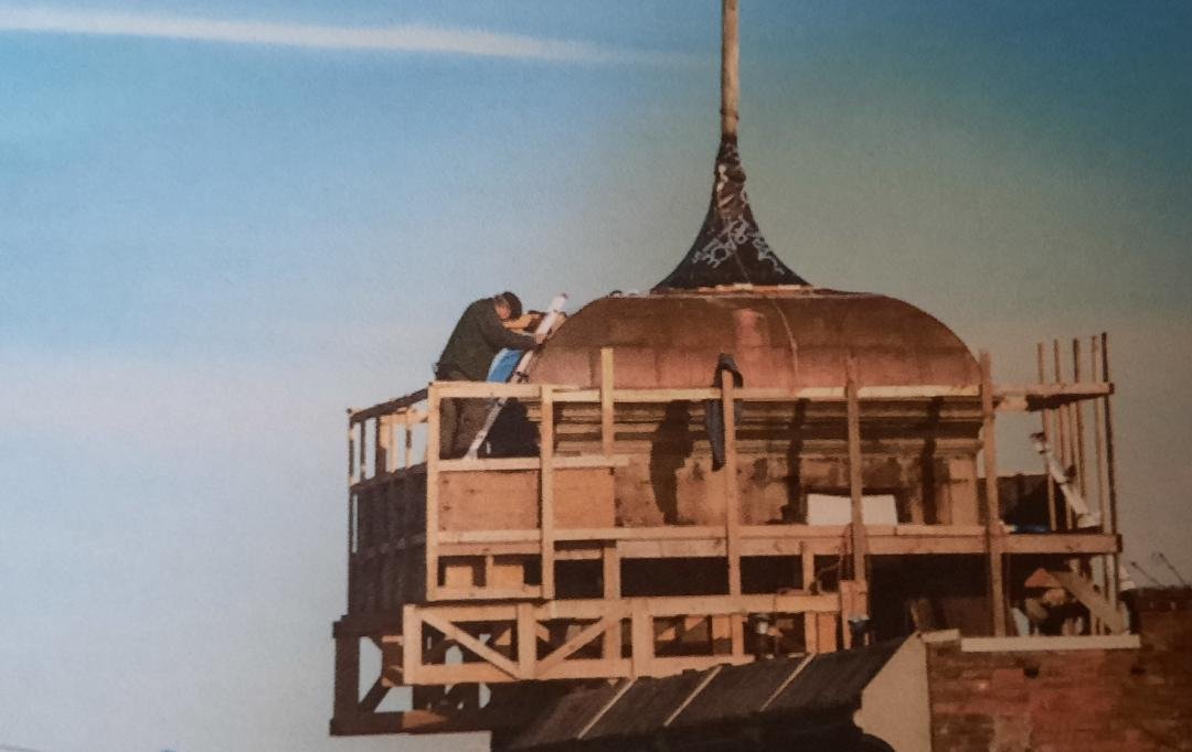   When the cost of a new roof on the building's cupola seemed expensive, David Hero decided to do the job himself. Photo courtesy of Alison Hero  