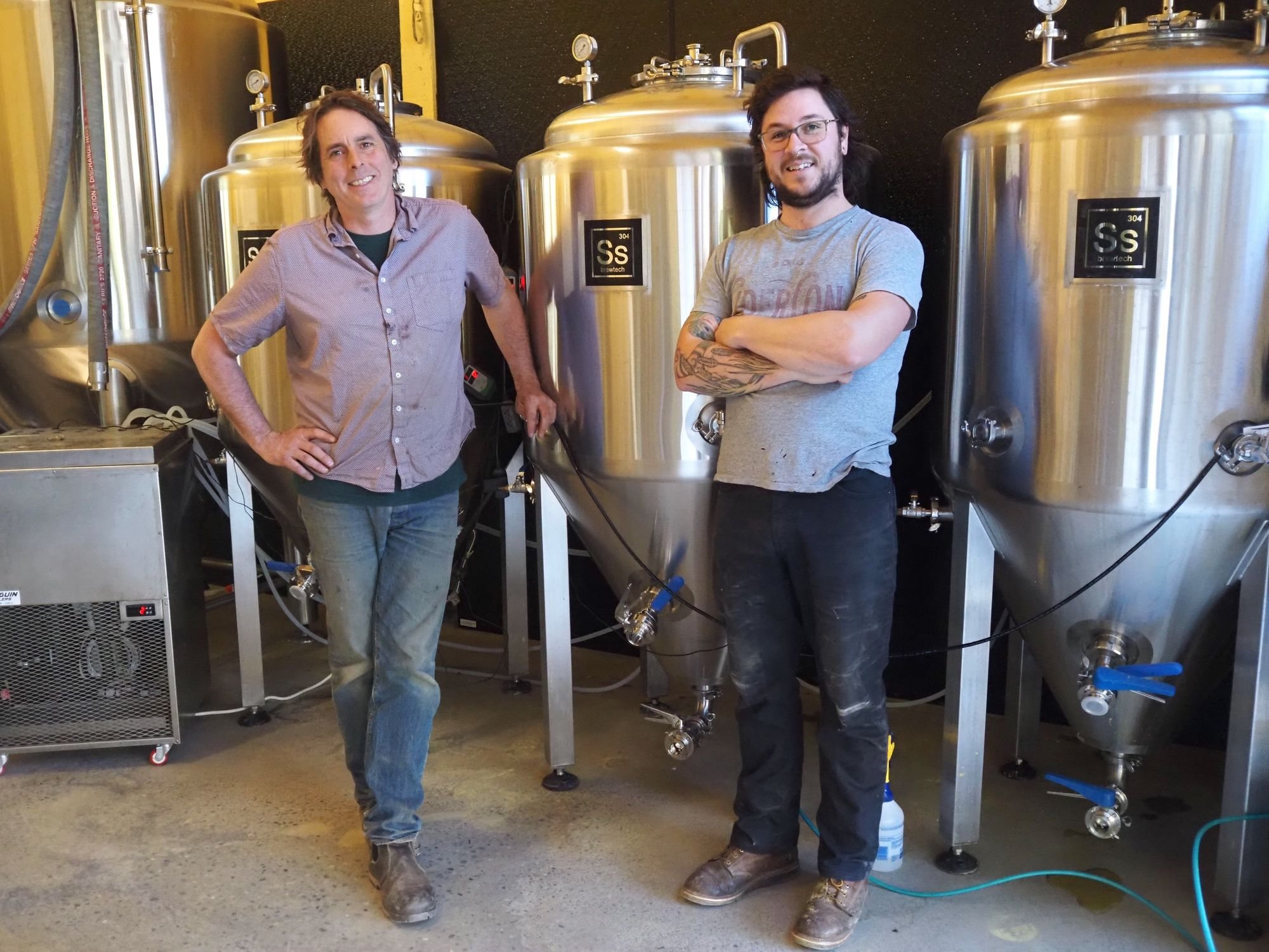   Keith Kisler and Sam Dressler work side by side to brew beer at Chimacum Valley Grainery. Beacon photo by Derek Firenze  