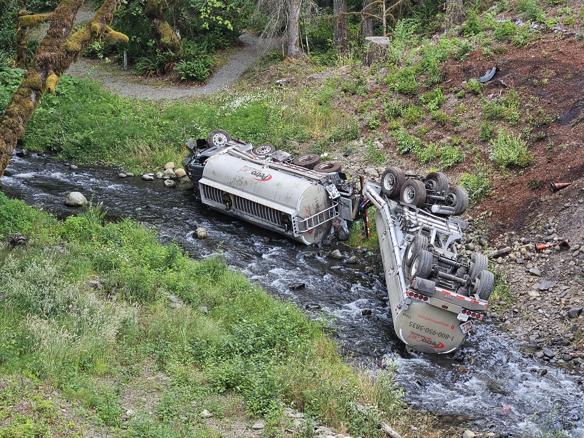  A fuel truck is seen overturned in Indian Creek in the Elwha River watershed after it crashed on Friday, July 18, 2025, near Port Angeles. (Photo courtesy of Clallam 2 Fire-Rescue)  