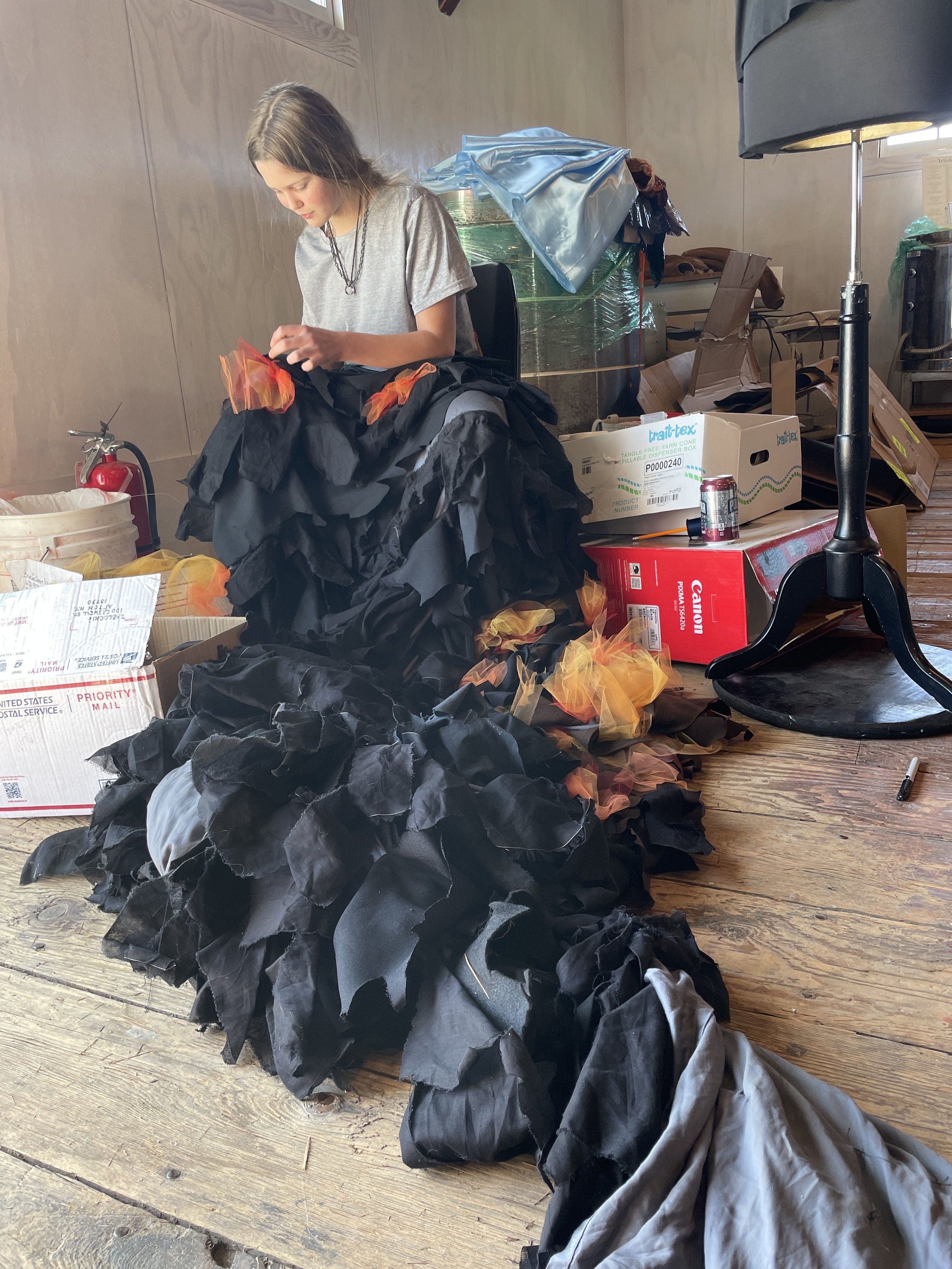   Josie Axling works on her piece, “Dying Ember.” Photo by Camille Hildebrandt.  