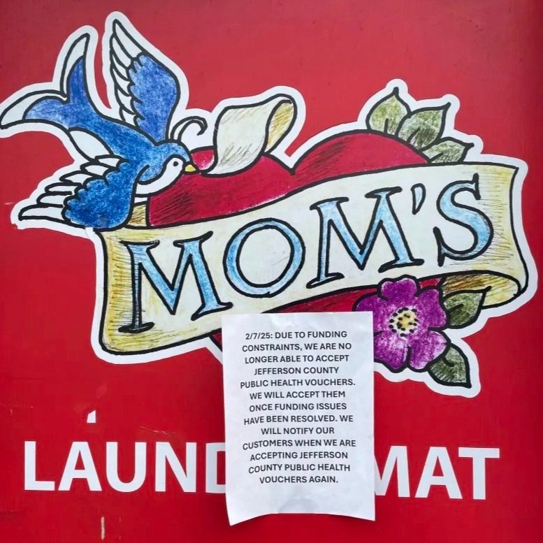   Sign at Mom’s Laundromat. Photo by Angela Downs.  