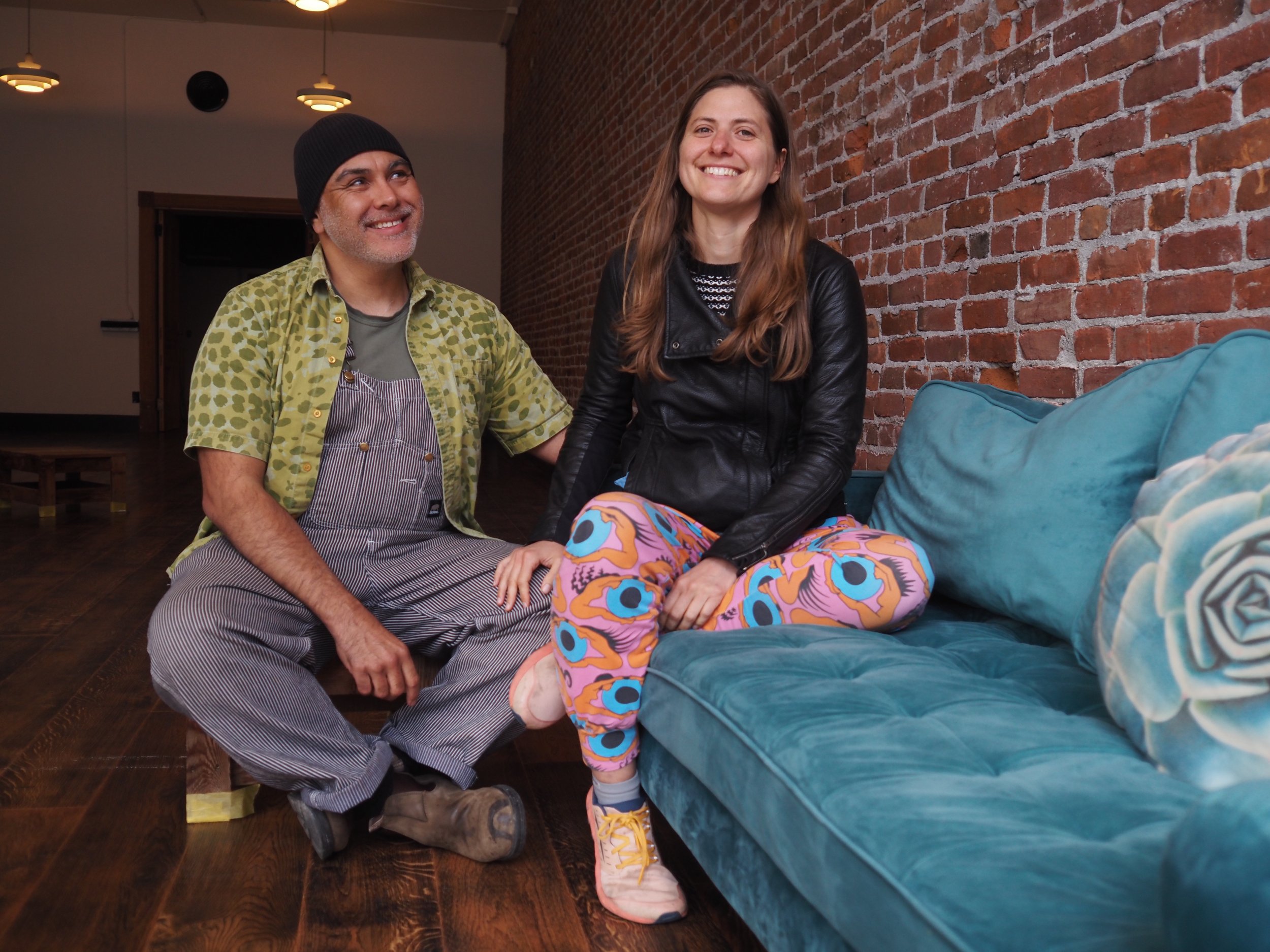   Pablo and Maria Qamara enjoy a moment on one of the couches they hope to fill their gathering space with. Photo by Derek Firenze  