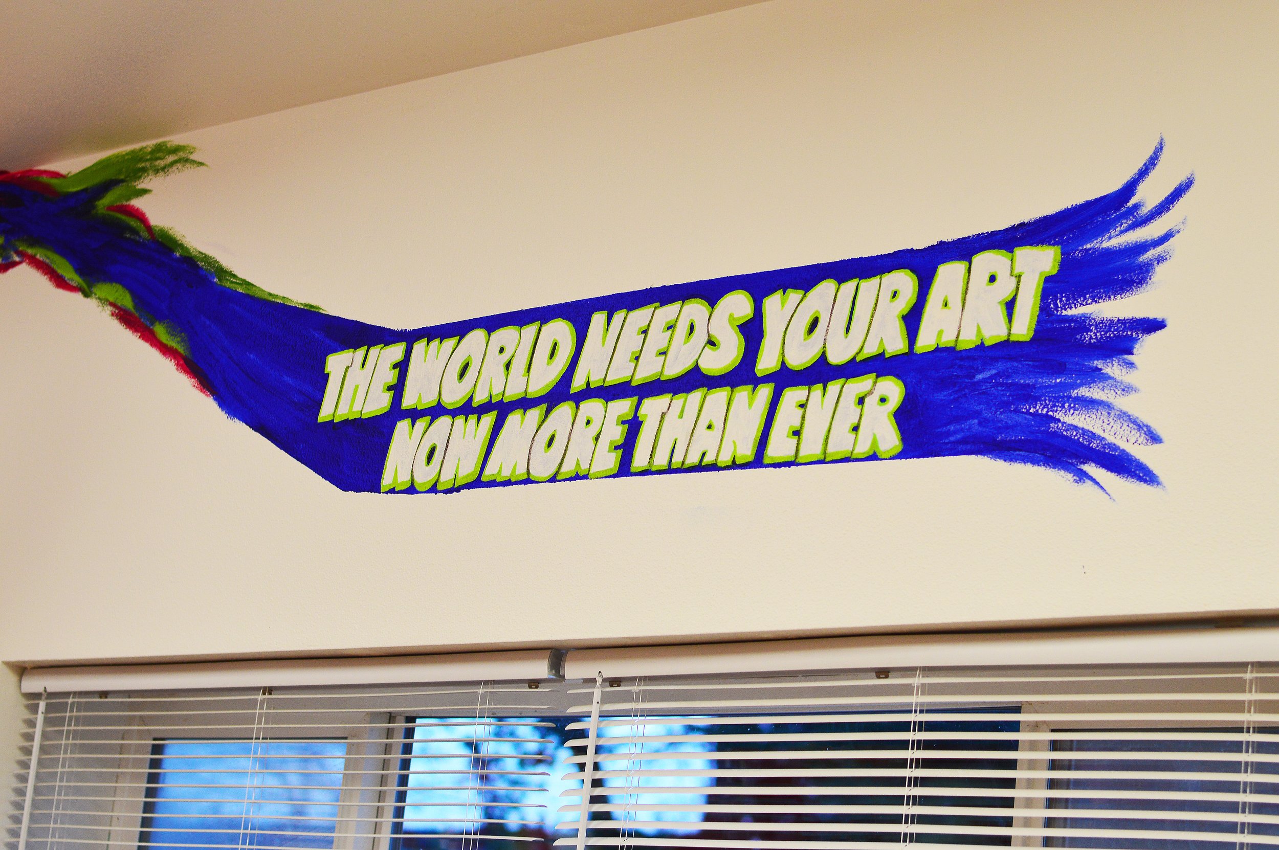   A painted message adorns the wall of the Park Avenue Studio art supply store. Photo by Diane Urbani de la Paz   