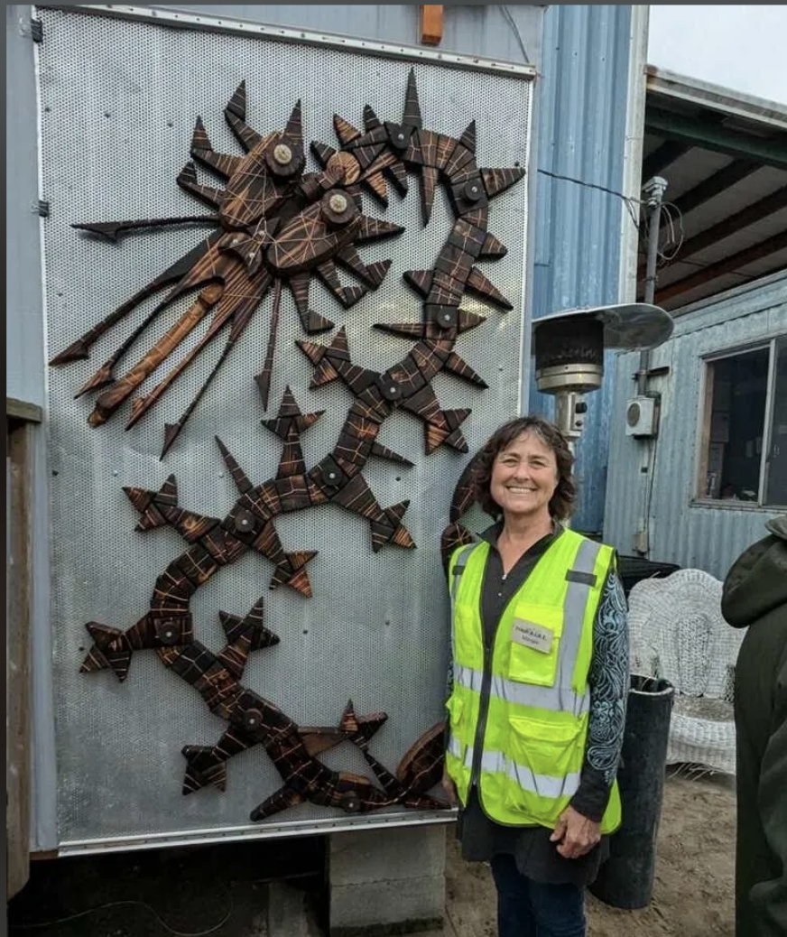   Margie McDonald poses next to her AIRE art.  