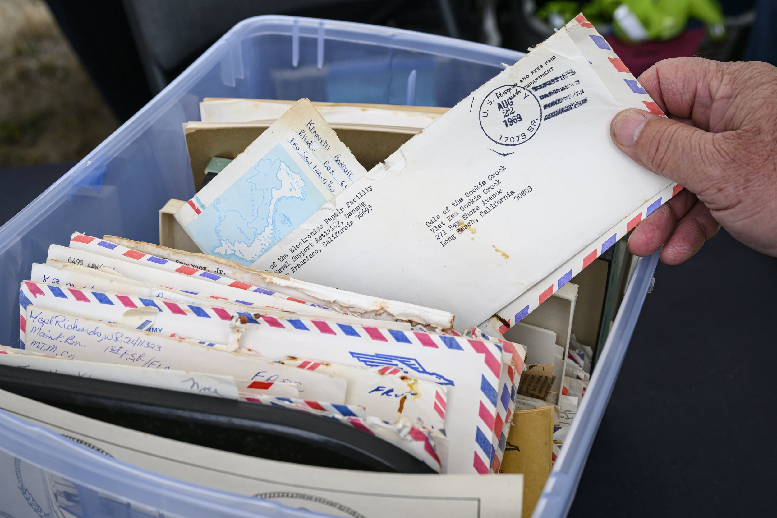   Steve Young pulls an envelope from a box of donated letters. The 