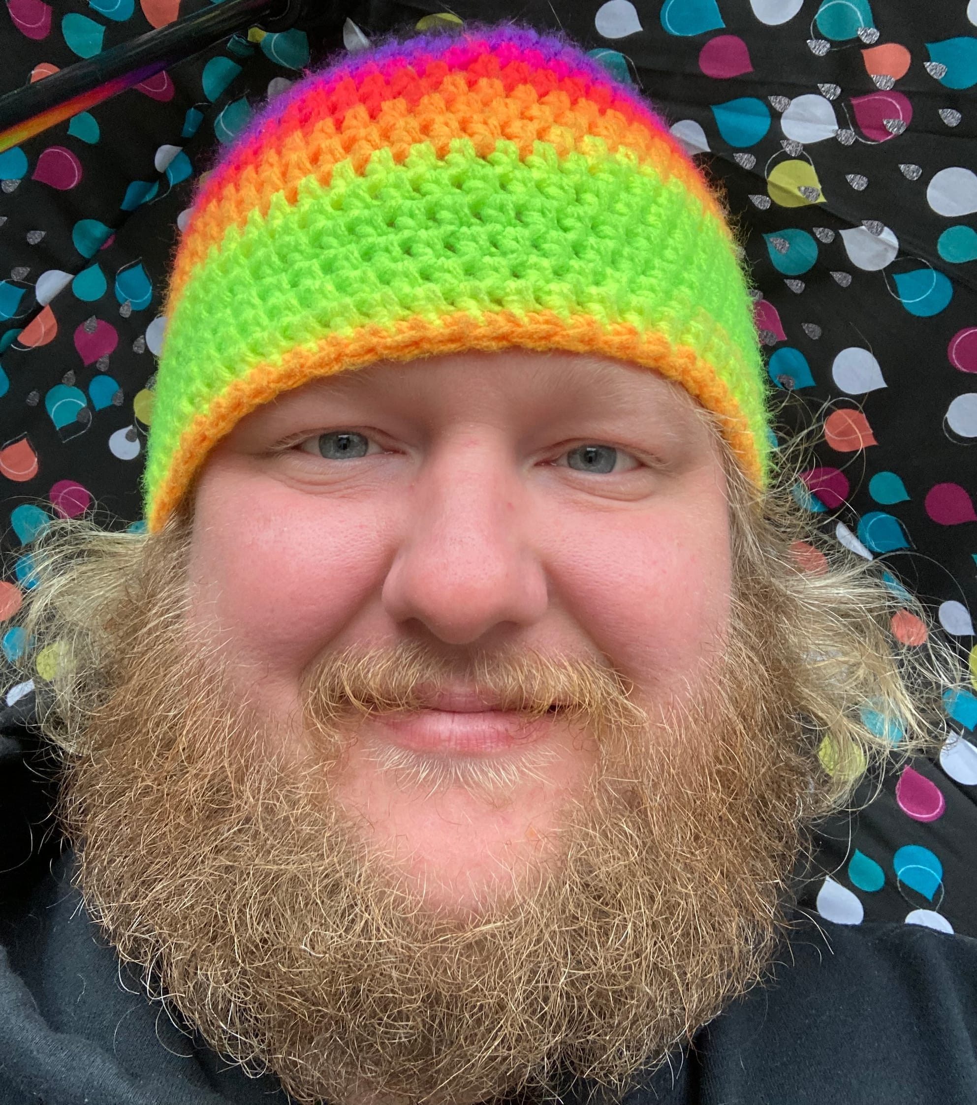 Paul Goodwin in a rainbow beanie