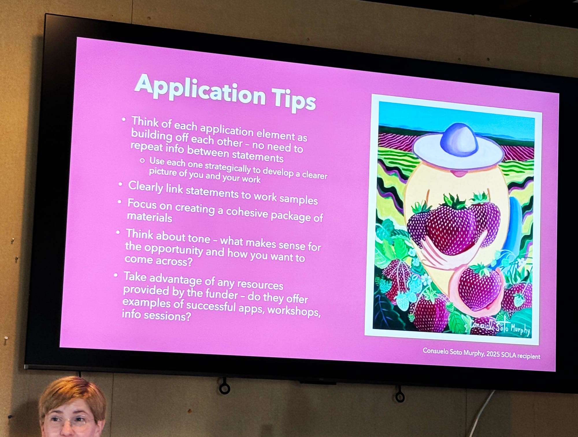 Anna Teiche, at lower left in front of a slide from her free class “Creating Opportunities for Your Art Career.”
