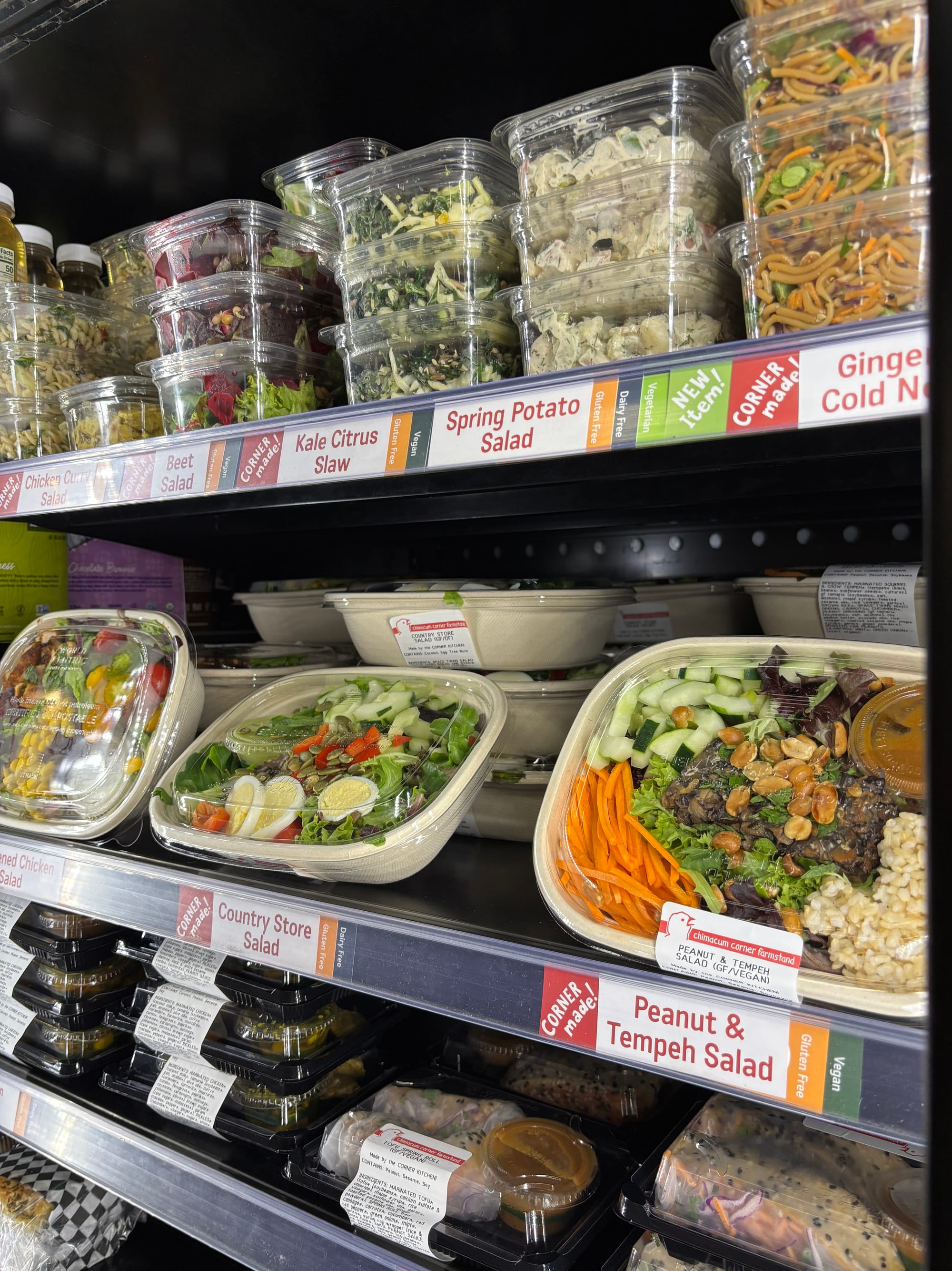 Salads and sandwiches in a cold case.