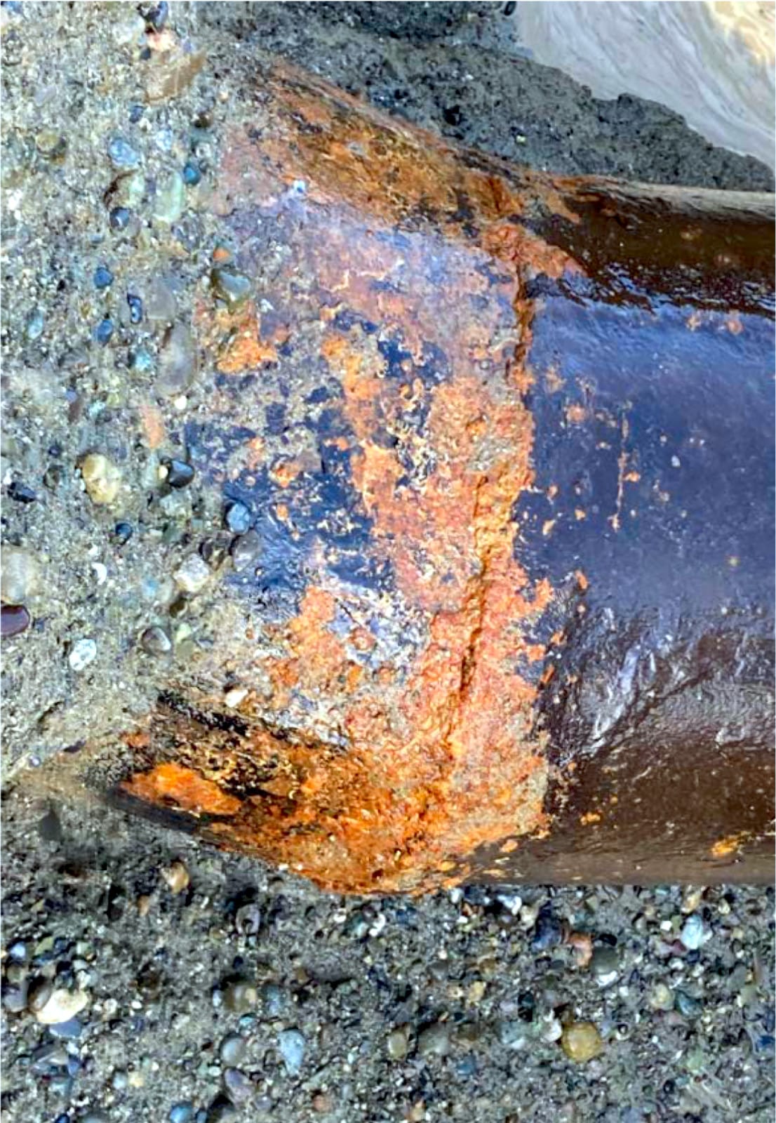 A section of the pipe from 1928 with a failing weld and compromised coating.