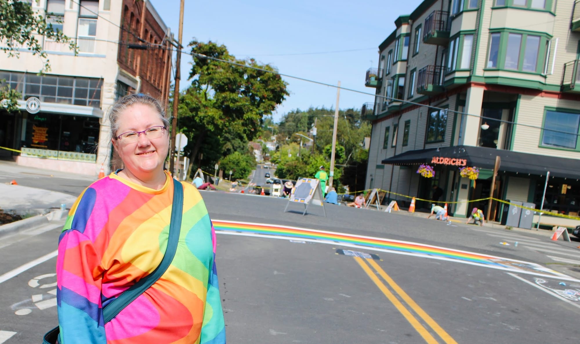 Mayor Amy Howard stands in front of the crosswalk at Lawrence and Tyler streets in her matching rainbow colors.