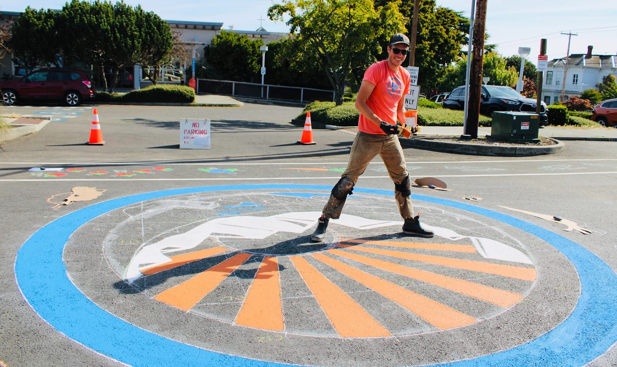 Kellen Lynch paints the Farmers Market mural in the center of Tyler Street.