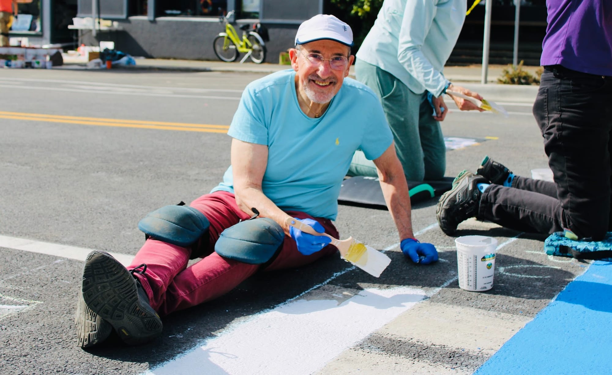 Jason Victor Serinus, paints one of the Tyler Street crosswalks.