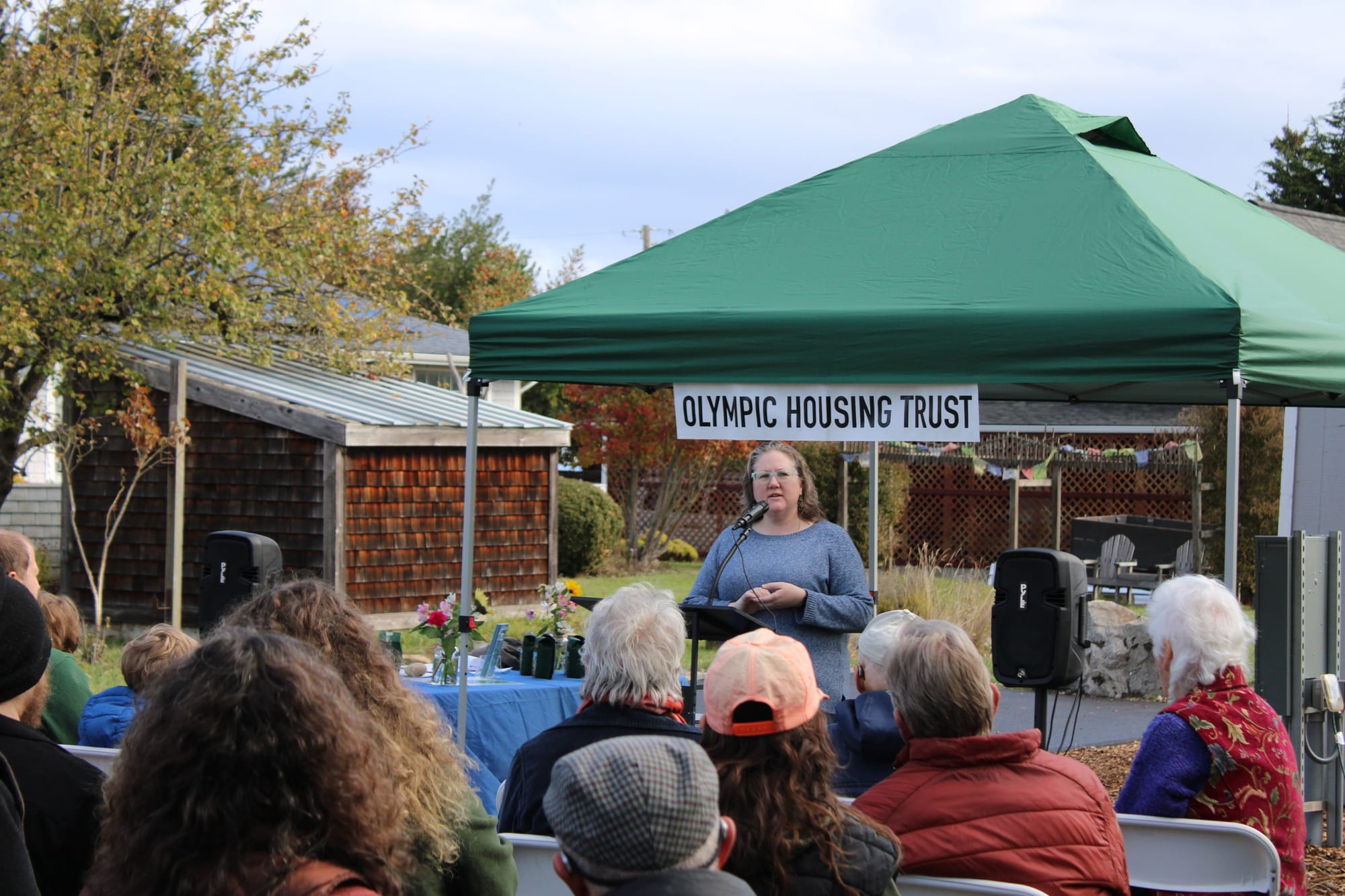 Port Townsend Mayor Amy Howard speaks to a crowd with a green tent in the background. 