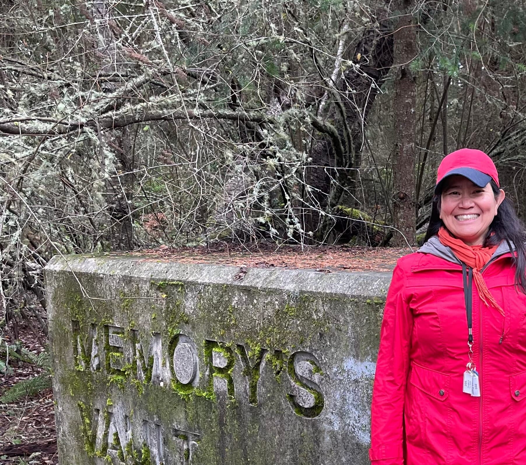 Rufina Garay in front of a mossy cement Memory's Vault, in wooded Fort Worden.