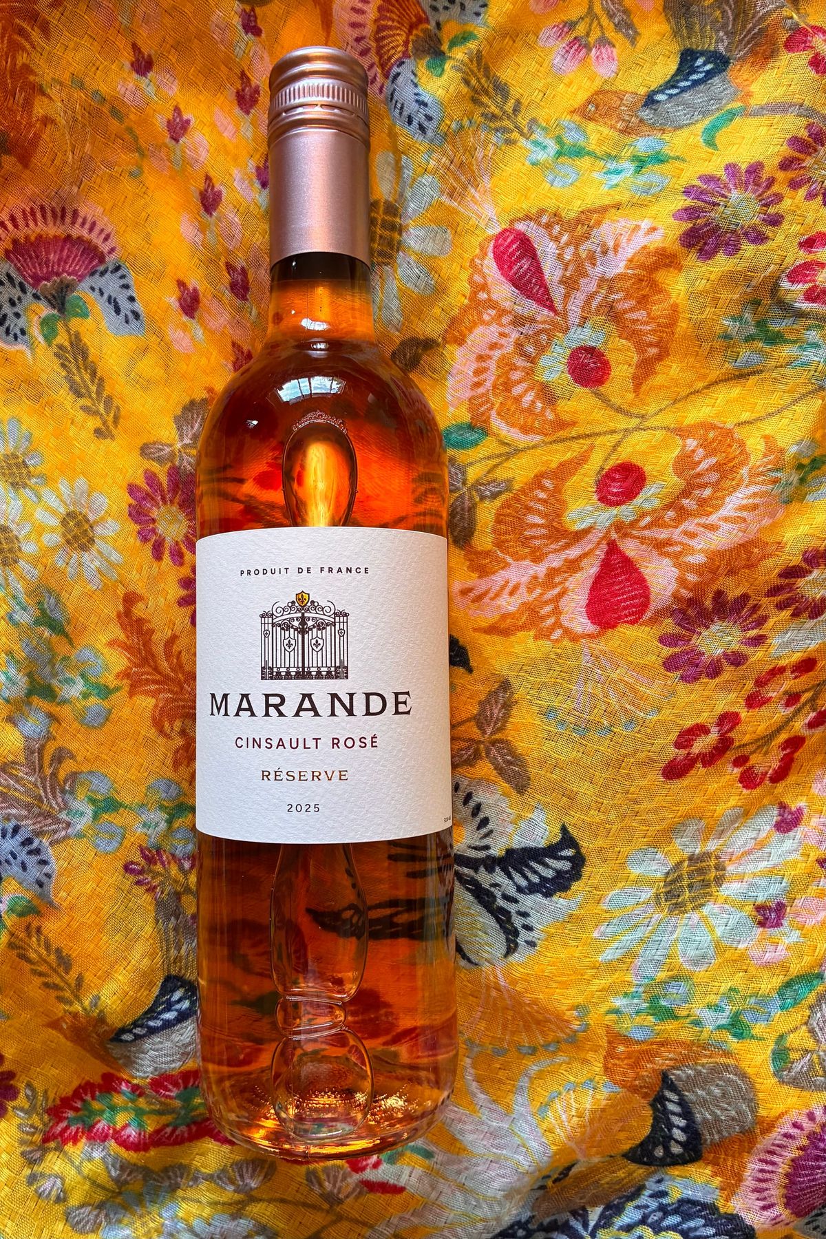 Produit De France, Marande Cinsault Rosé Reserve 2025, a blush bottle of rosé on a bright yellow patterned tablecloth.
