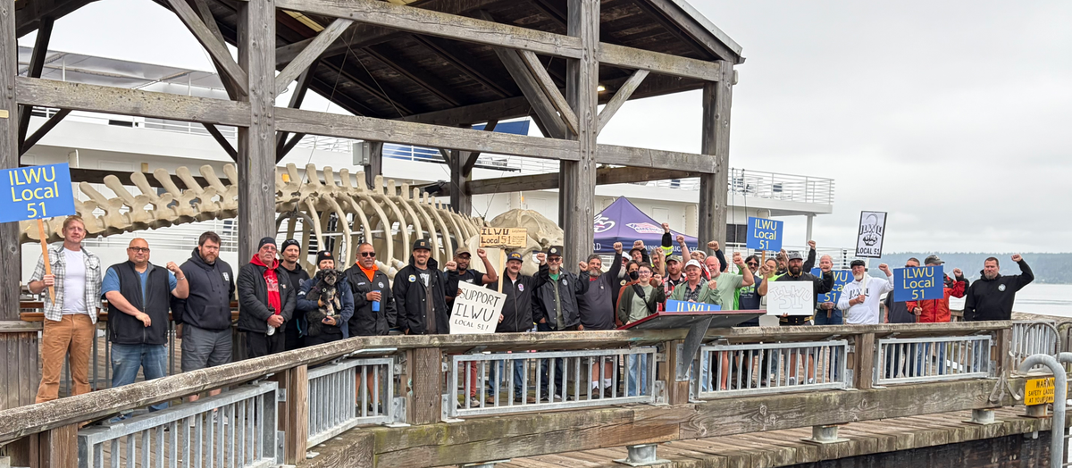 International Longshoremen and Warehouse Union members picketing on the Union Wharf dock, whale skeleton and cruise ship in background. 