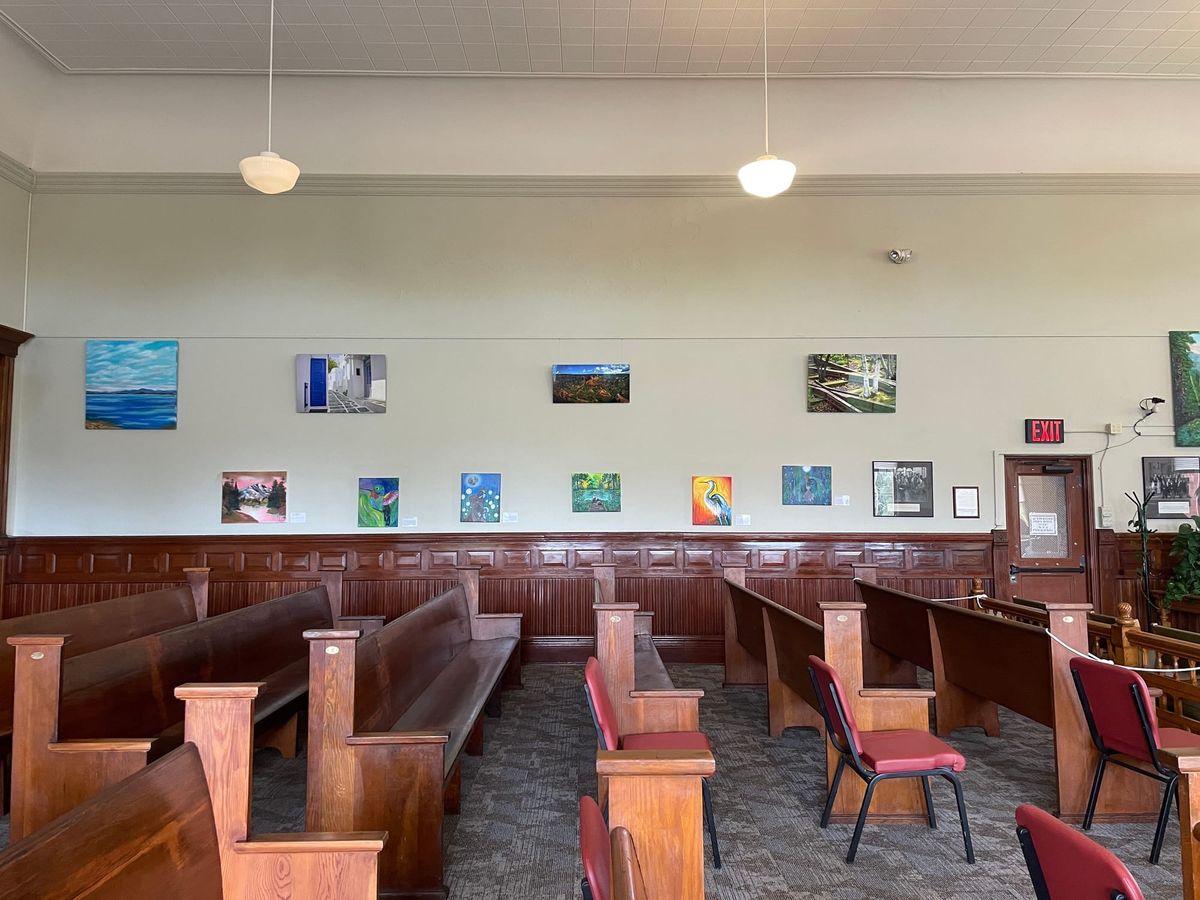 Superior Courtroom north wall with local art, gallery benches in the foreground. 