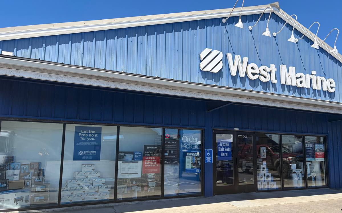 West Marine in Port Townsend, WA. A blue metal building with glass doors and display windows. 