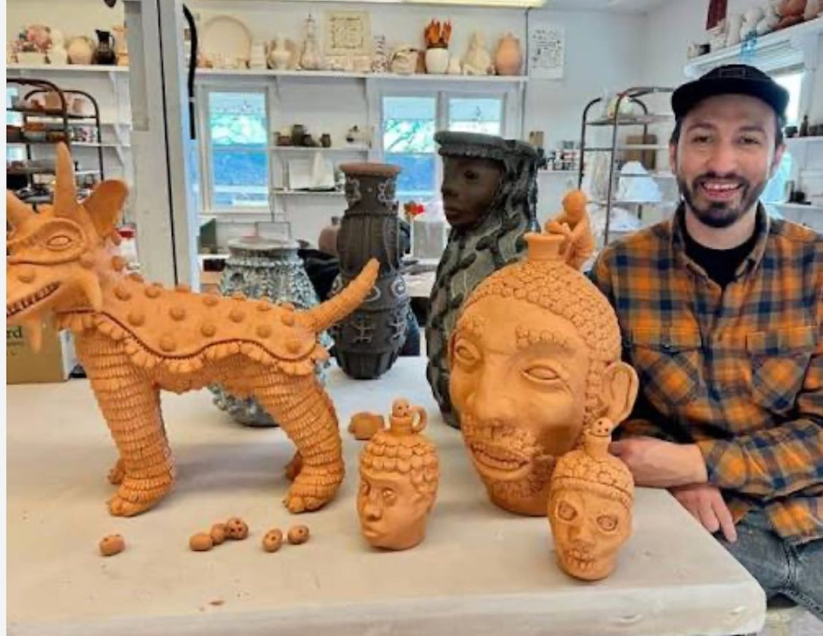 Ceramic sculptor George Rodriguez with some of his clay creations. 