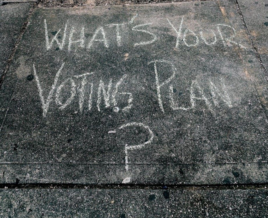 "What's Your Voting Plan?" written in chalk on a sidewalk.
