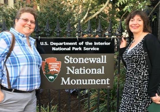 Susan Ferentinos (left), Megan Springate (right), Stonewall National Monument sign in the center of the photo. 