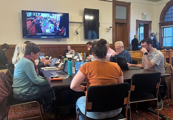 Planning Commissioners, Planning Staff and City Council gathered around a table 