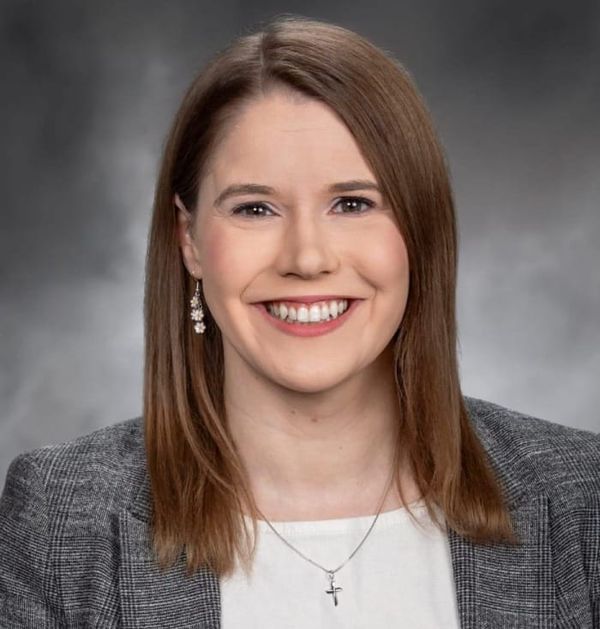 Representative Lauren Davis in white shirt and gray blazer 