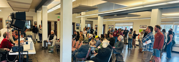 Port Townsend Community Center interior with County Commissioners on the left and audience to the right. 