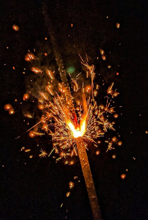 A picture of a lit fuse in the dark. 