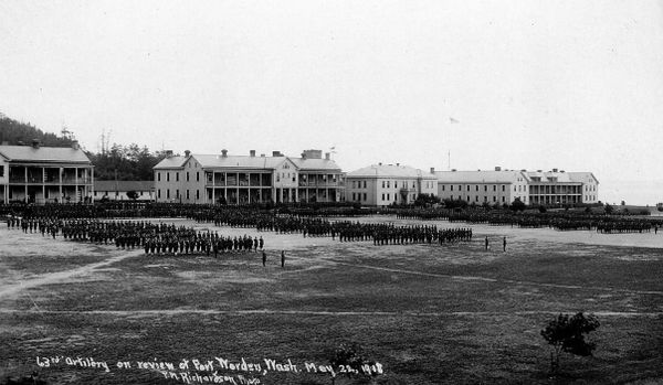 A black and white photo of soldiers in formation in front of barracks Building 202 (left), Building 201, Building 200 and Building 225.