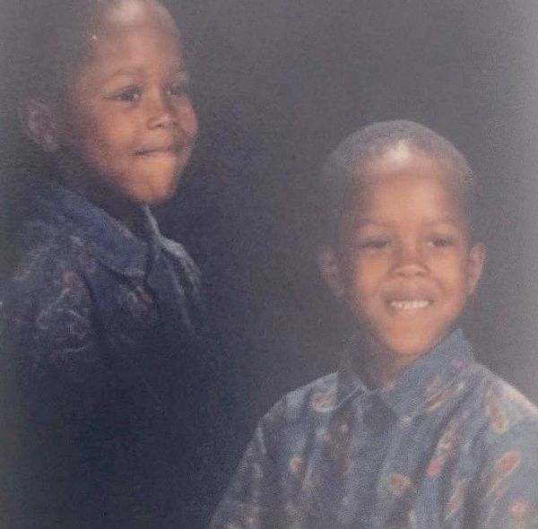 A smiling child in their school photo with a patterned short sleeve shirt on.