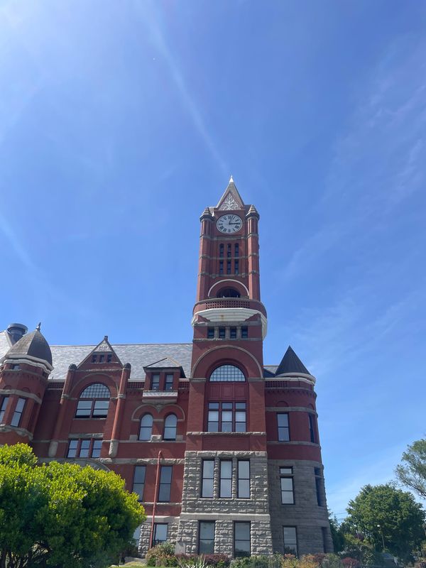 Jefferson County Courthouse, a red brick building with a clock tower on the right side. 