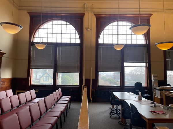 Jefferson County District Courtroom from one side of the gallery facing large windows with blinds.