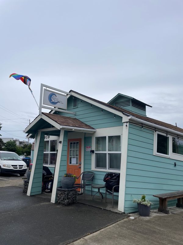 Recovery Café, a building with turquoise siding and an orange door. 