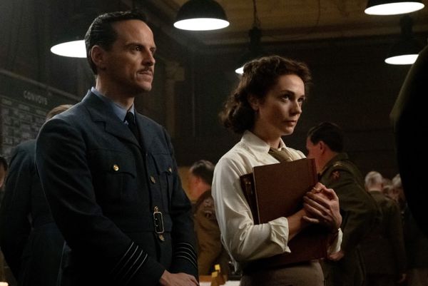 Andrew Scott, left, in a blue uniform jacket and Kerry Condon, right, in a shirt and tie holding folders. 