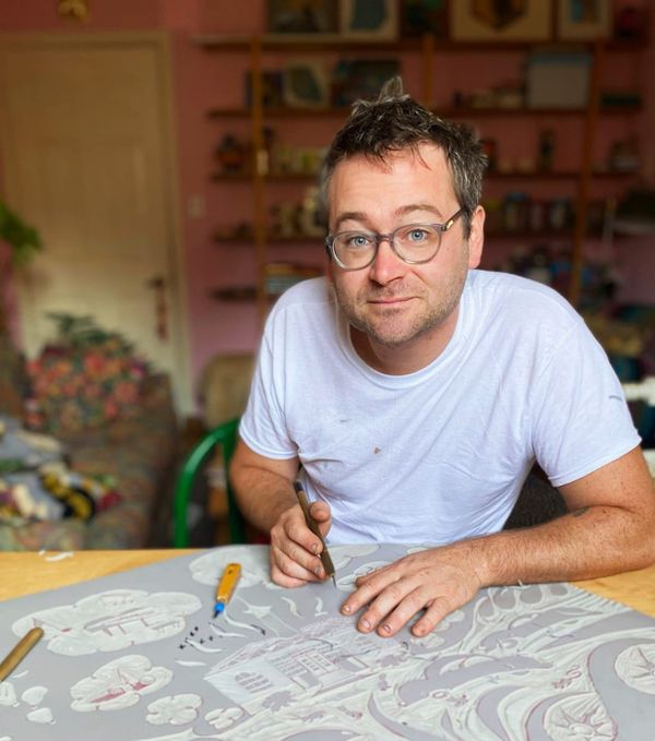 Woodcut printmaker Charles Spitzack with one of his woodcuts. 